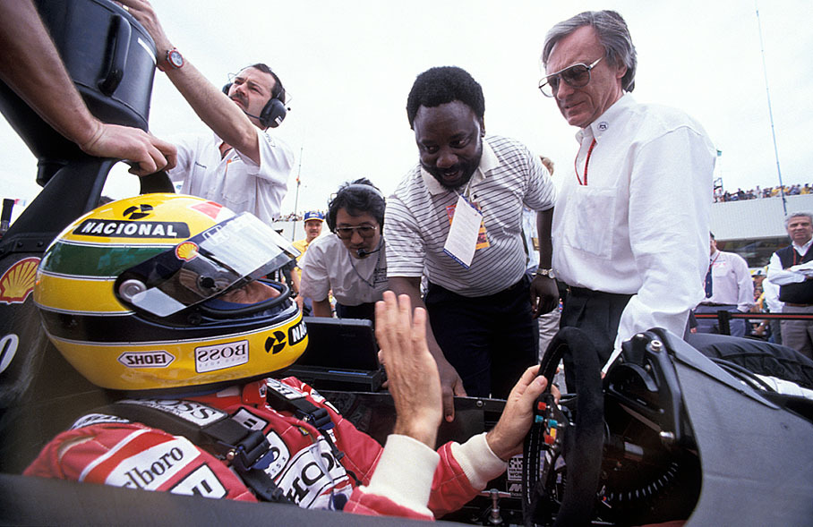 Bernie Ecclestone and a VIP (South African sporting minister?) visit Senna at the grid position