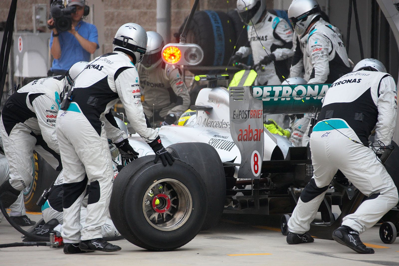 Rosberg's Mercedes is serviced at Mercedes Grand Prix pits