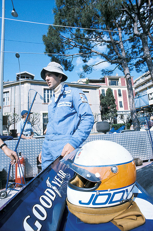 Jody Scheckter stands on the grid besides the Tyrrell-Cosworth 007 prior to the Monaco GP Monte Carlo 1975