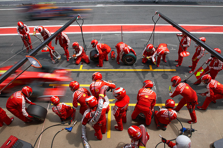 Felipe Massa approaches Ferrari pits, Vettel passes by on pit lane