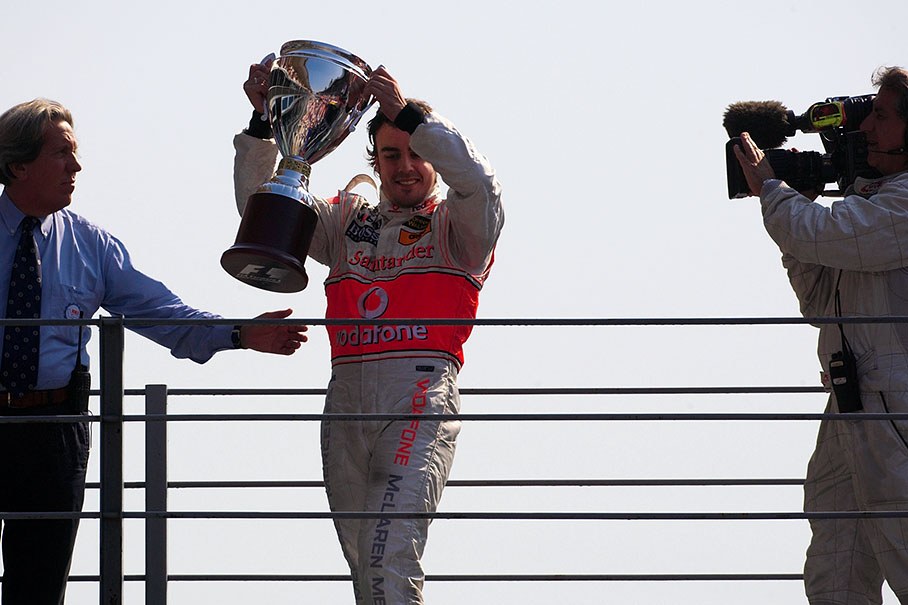 Race winner Fernando Alonso proudly presents his trophy