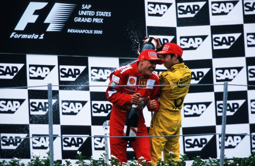 Heinz-Harald Frentzen sprays champagne at Michael Schumacher