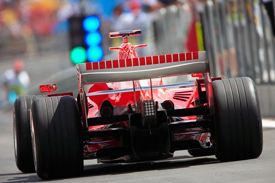 Michael Schumacher gets green lights to go on track - blue lights indicate to pay attention to a passing car at pitlane exit
