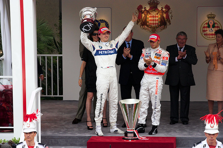 Happy second placed Robert Kubica raises his deserved cup