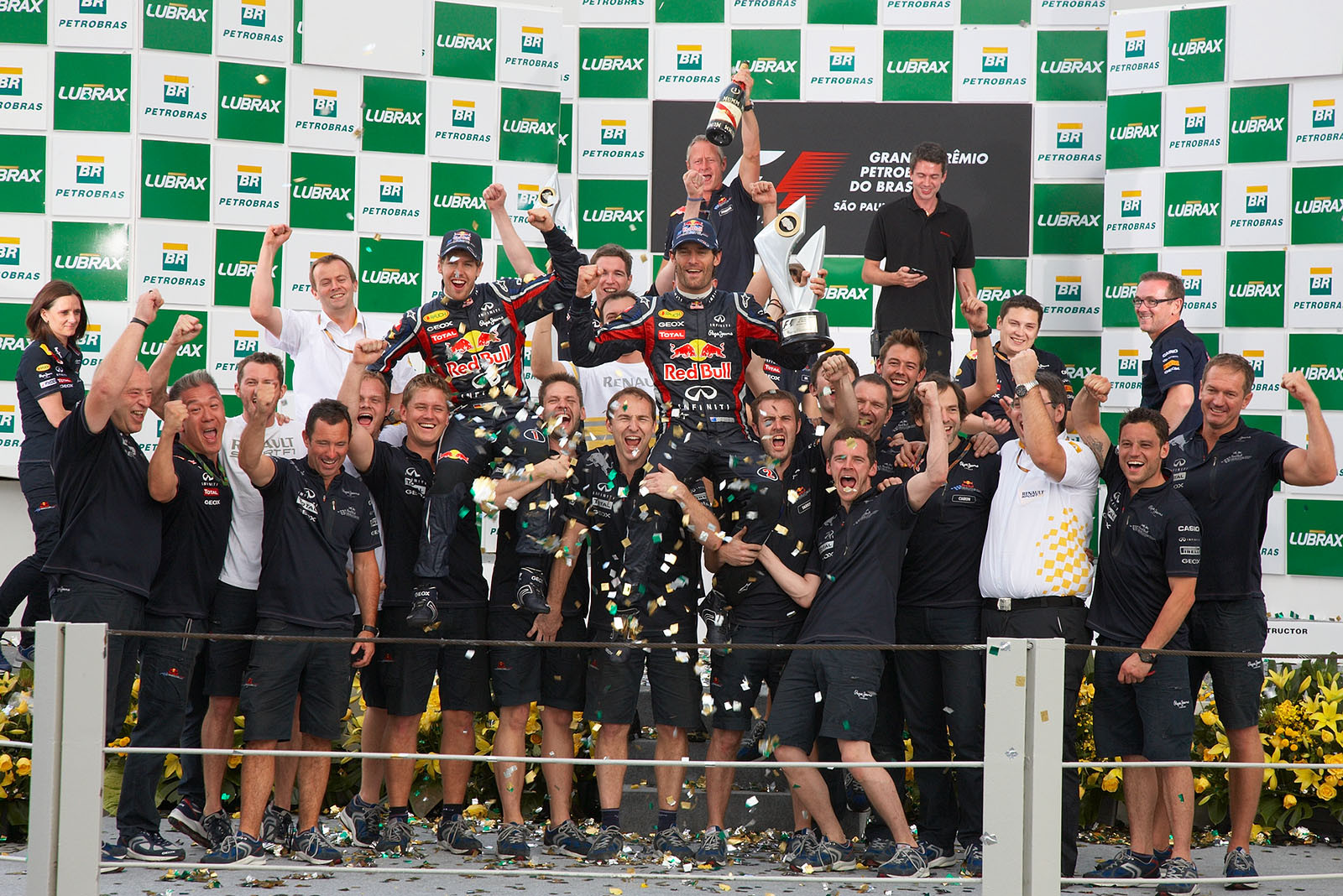 The whole Red Bull Racing team celebrates the superior success with Renault engineers subsequent to the podium ceremony after the Brazilian GP
