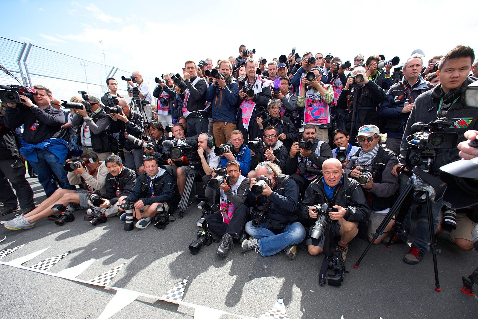 Photographers wait for the race drivers
