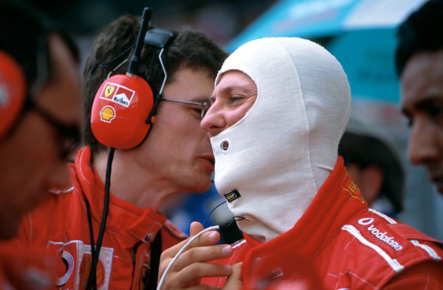 Michael Schumacher listening to the remarks of his race engineer Chris Dyer