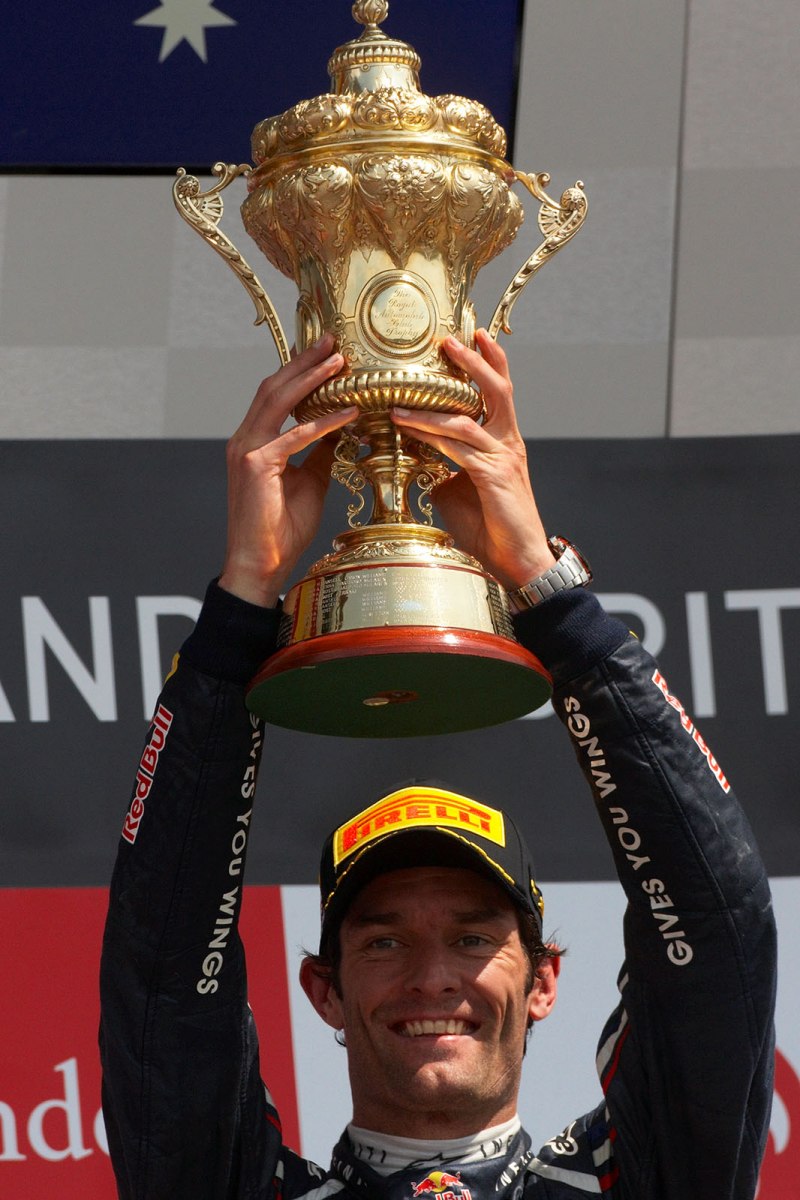 Race winner Mark Webber of Red Bull Racing presents his trophy for the winning driver