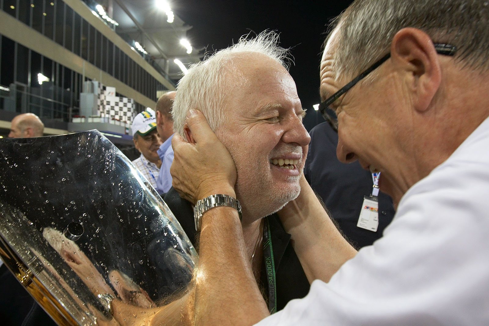 A happy Norbert Vettel receives congrats from Red Bull's Burghard Hummel