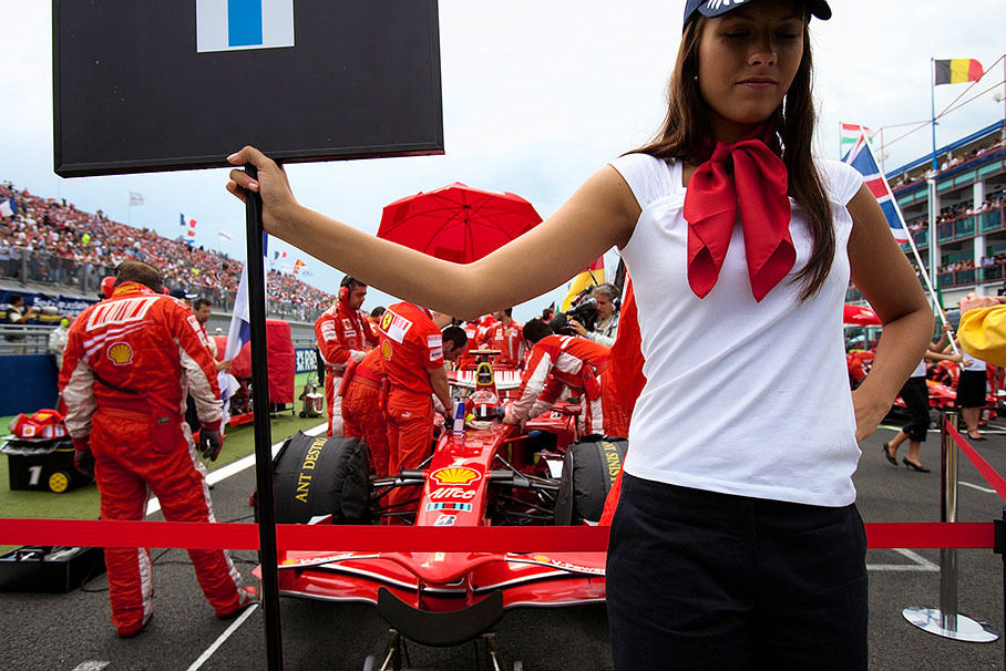 Kimi Raikkonen and his Ferrari are being prepared on the grid