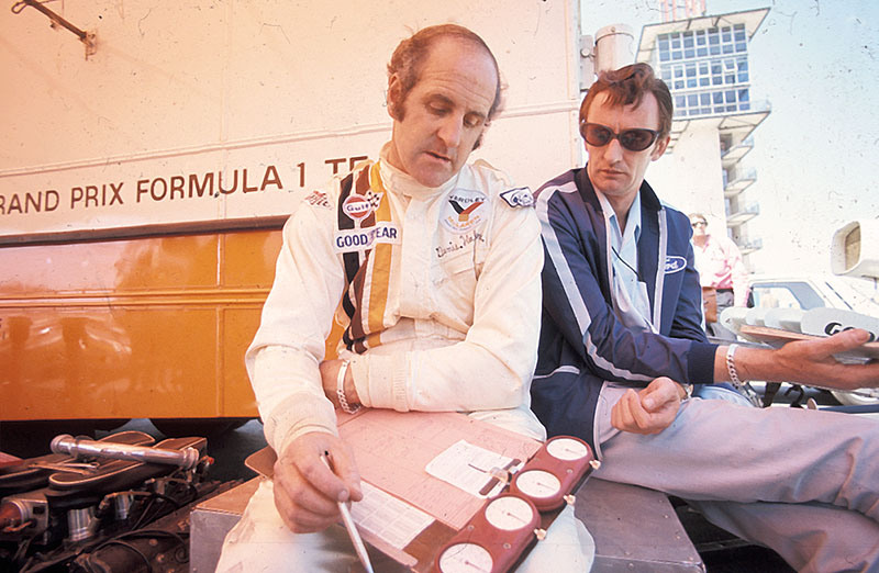 Denny Hulme checks a timesheet in McLaren paddock, Monaco GP Monte Carlo 1972