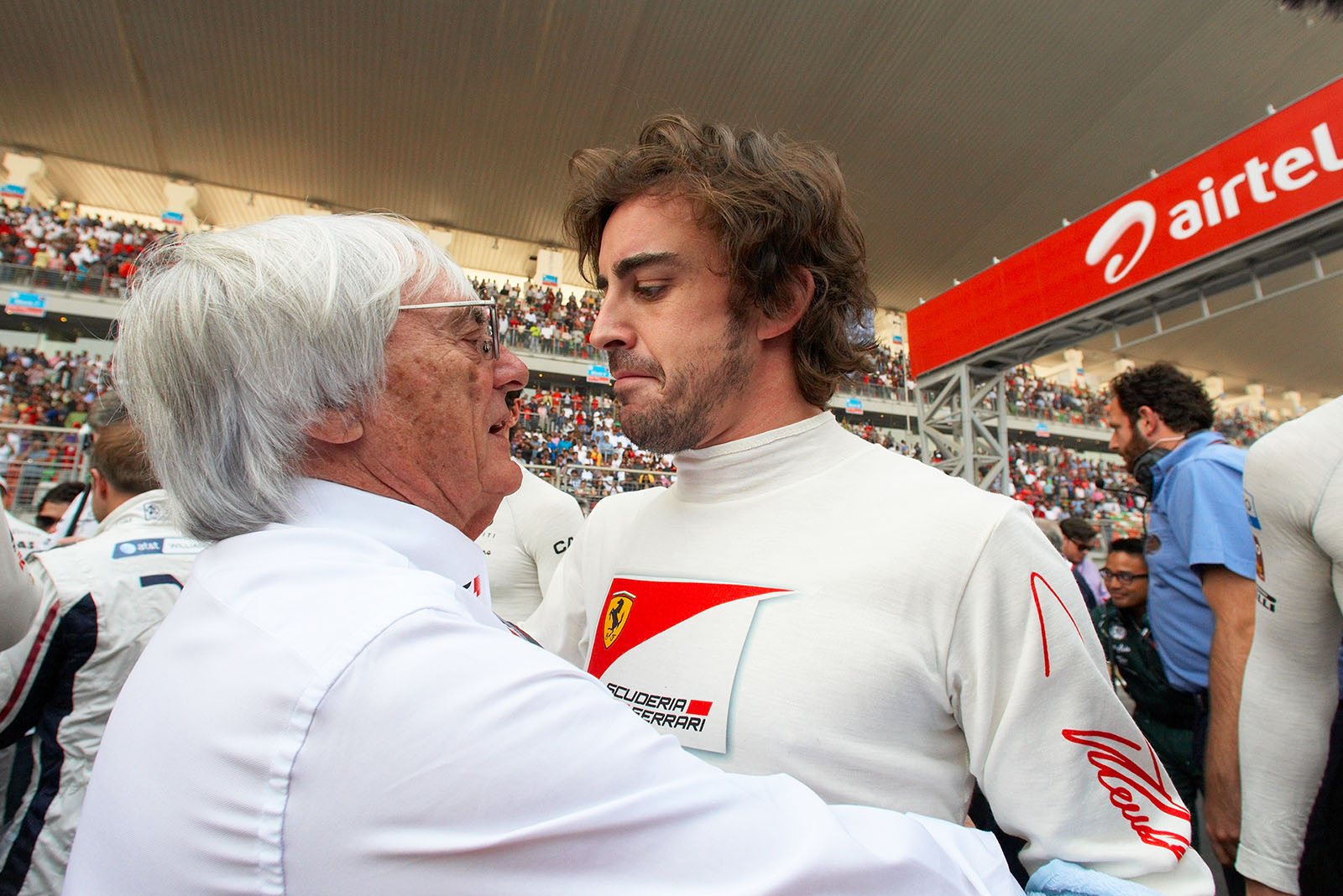 After the minute's silence on the grid, a very sad looking Fernando Alonso walks into the arms of Bernie Ecclestone who speaks a serious word