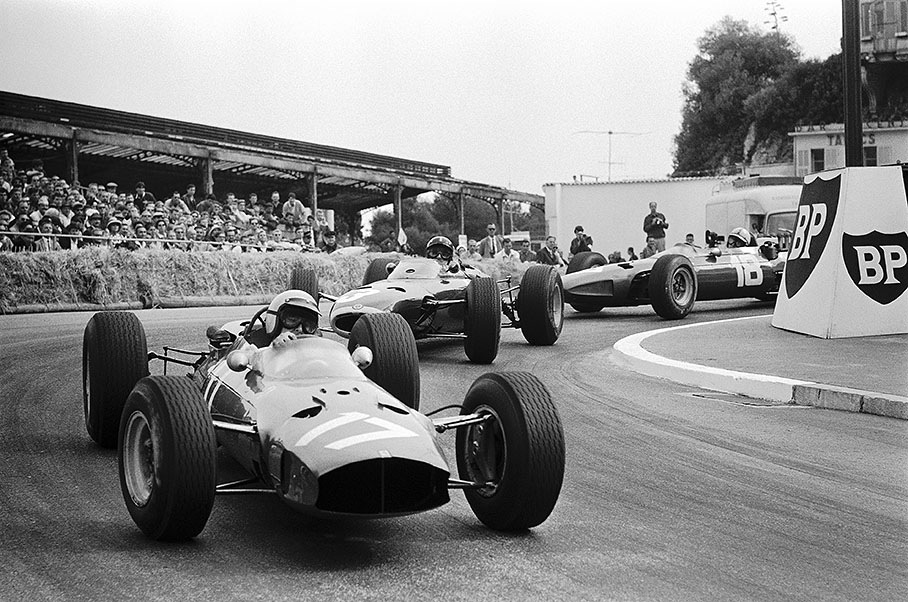Italian Lorenzo Bandini, Ferrari 1512, leads later race winner Graham Hill on BRM P261 and John Surtees' Ferrari through the Station hairpin, Monaco GP 1965