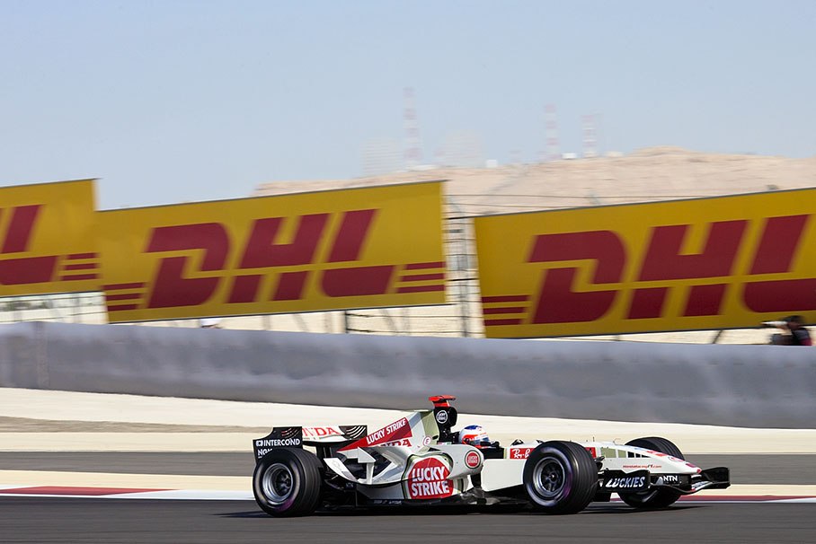 Rubens Barrichello in front of huge DHL billboards