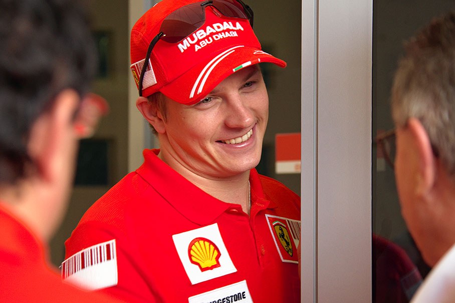 Kimi Raikkonen, obviously happy about 19 points in the championship lead, chats with his manager Robertson