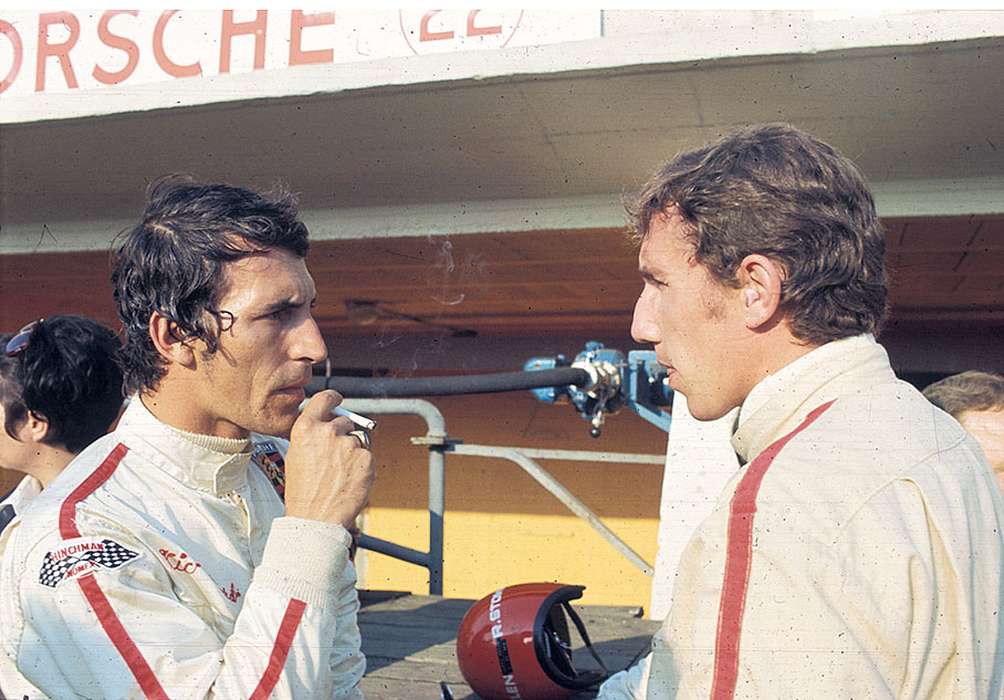 Vic Elford chats with Rolf Stommelen while smoking a deserved cigarette