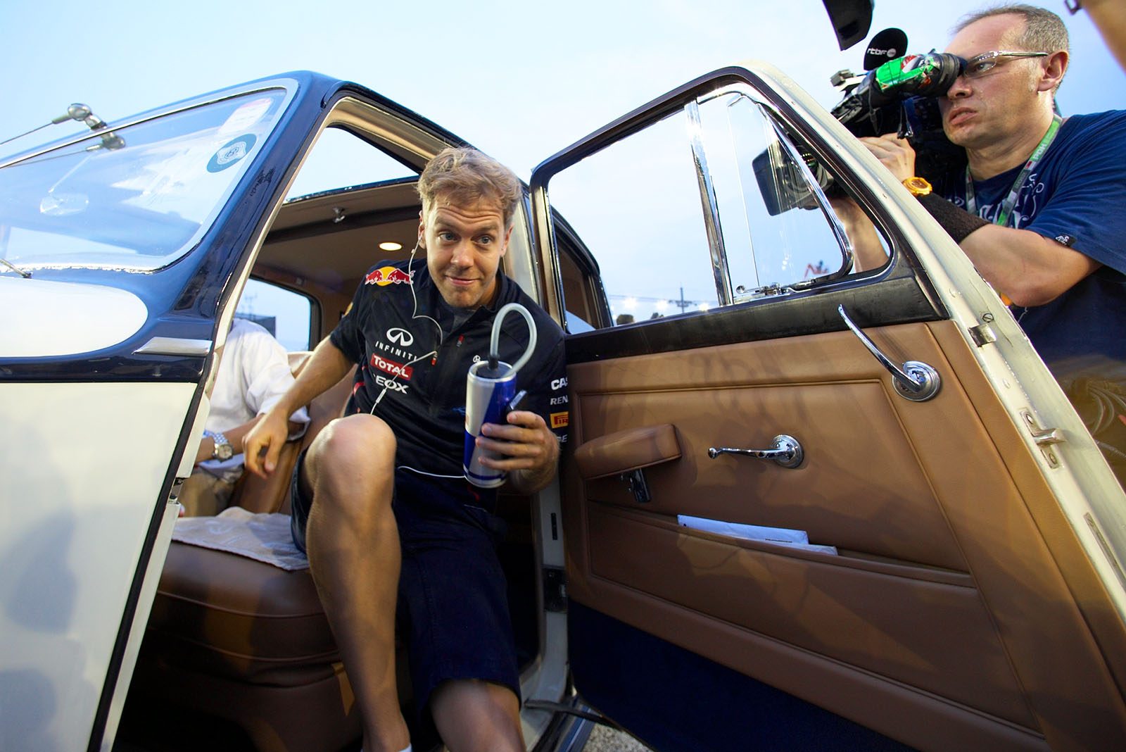 Sebastian Vettel of Red Bull Racing returns from drivers parade in a historic car