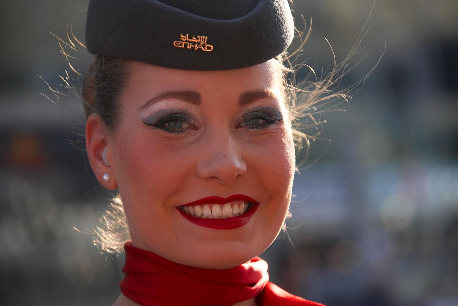 A perfectly made up stewardess of the main sponsor Etihad airlines