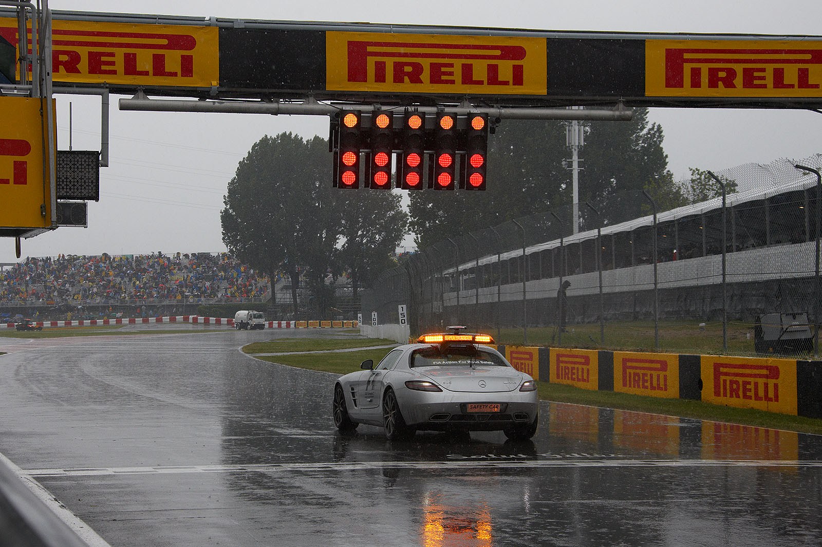 The safety car stands in position for a soon restart of the rainy race