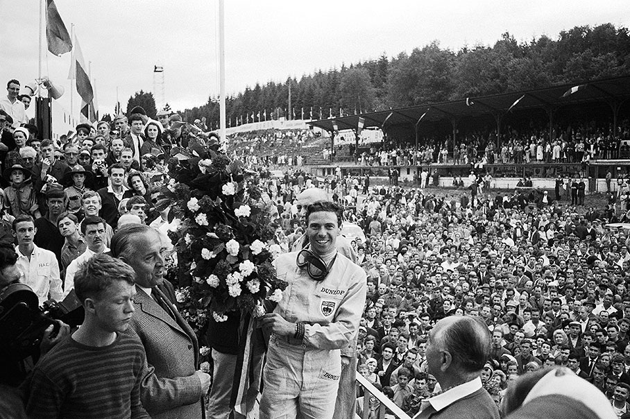 Jim Clark, winner of the Belgian GP 1964, takes a bath in the masses after his successful race.