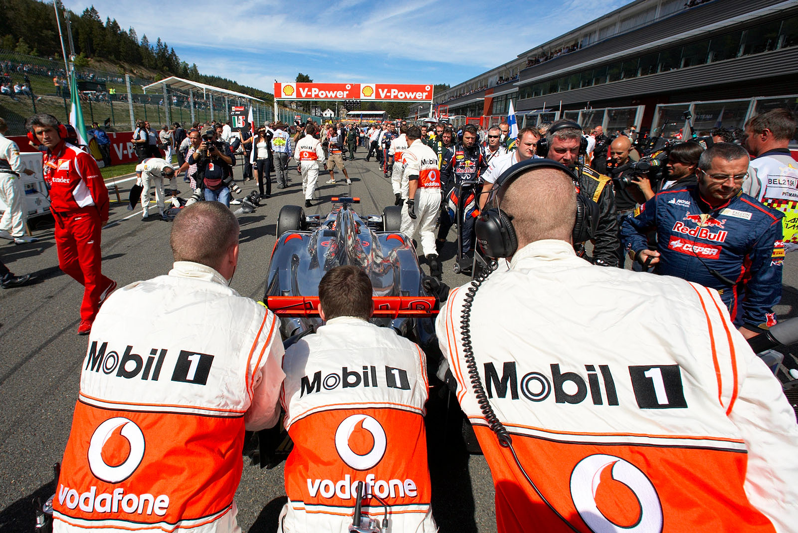 Jenson Button, McLaren Mercedes, is pushed to pole position