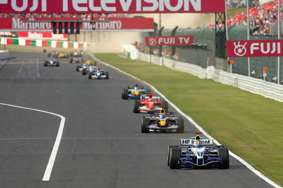 Mark Webber leading the cueue - note Juan Pablo Montoya's accident in the background dirt cloud.
