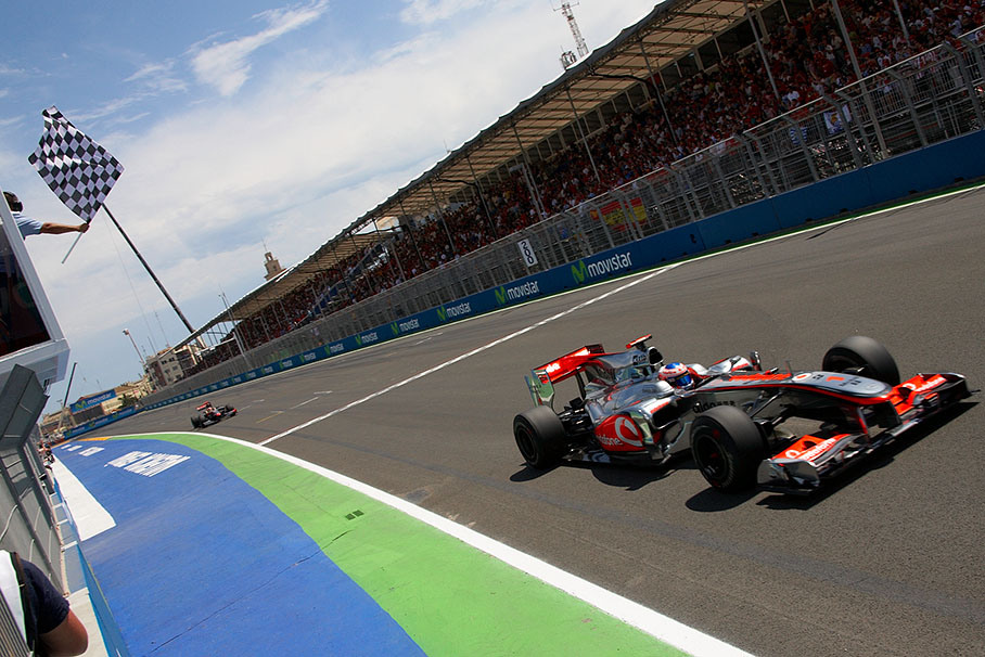Third placed World Champion Jenson Button of McLaren Mercedes takes the chequered flag