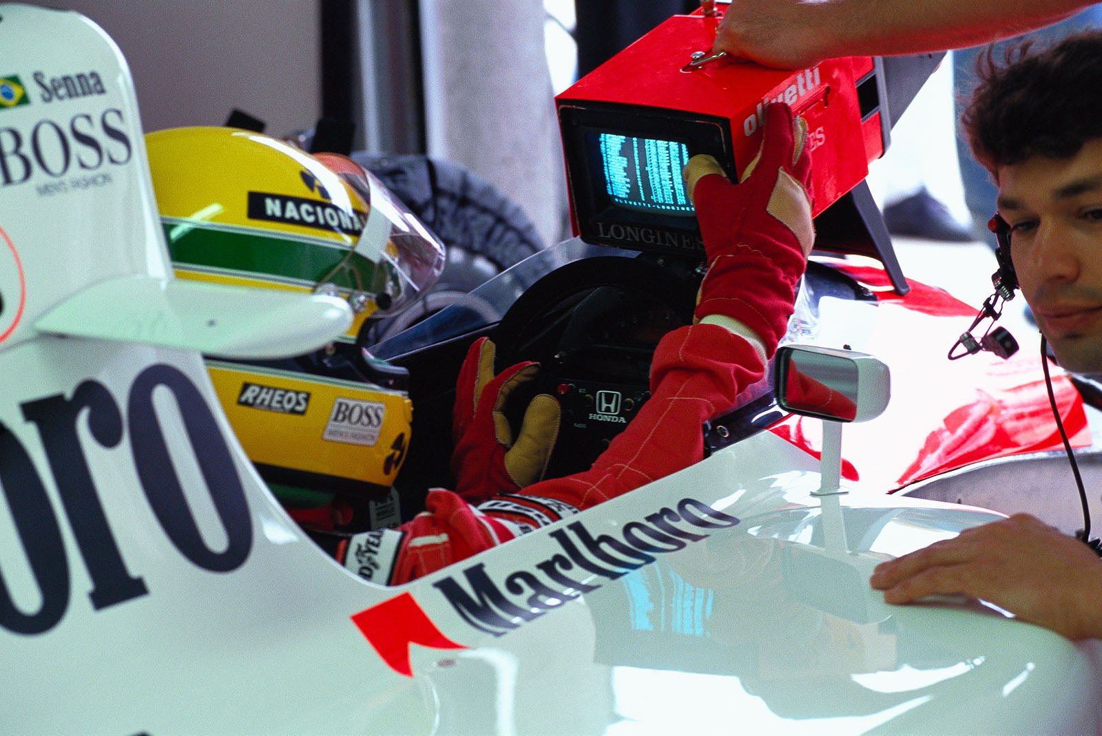 McLaren driver Ayrton Senna looks at the practice times. Next to him his race engineer James Robinson.