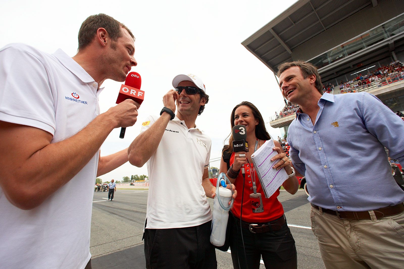 Former colleagues Alex Wurz, Pedro de la Rosa and Adrian Campos do TV interviews on the grid before the Spanish Grand Prix 2012