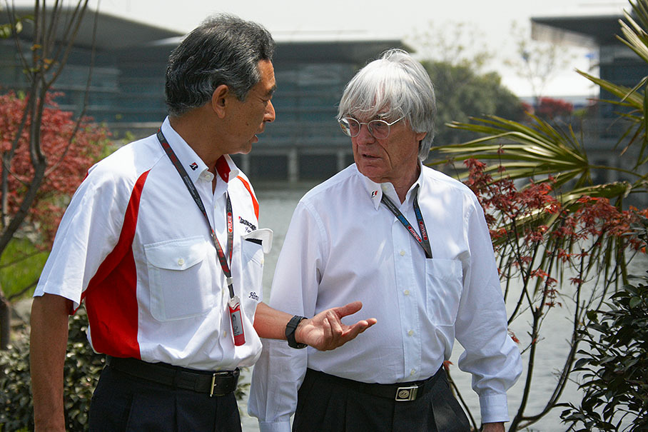 Hiroshi Yasukawa, Director of Bridgestone Motorsport, discusses with Bernie Ecclestone