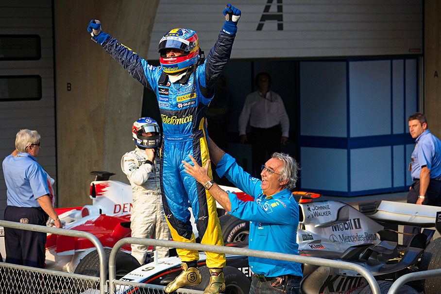 Fernando Alonso jumping on the parc ferme fence.