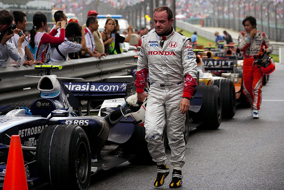 Rubens Barrichello walks back after a difficult race