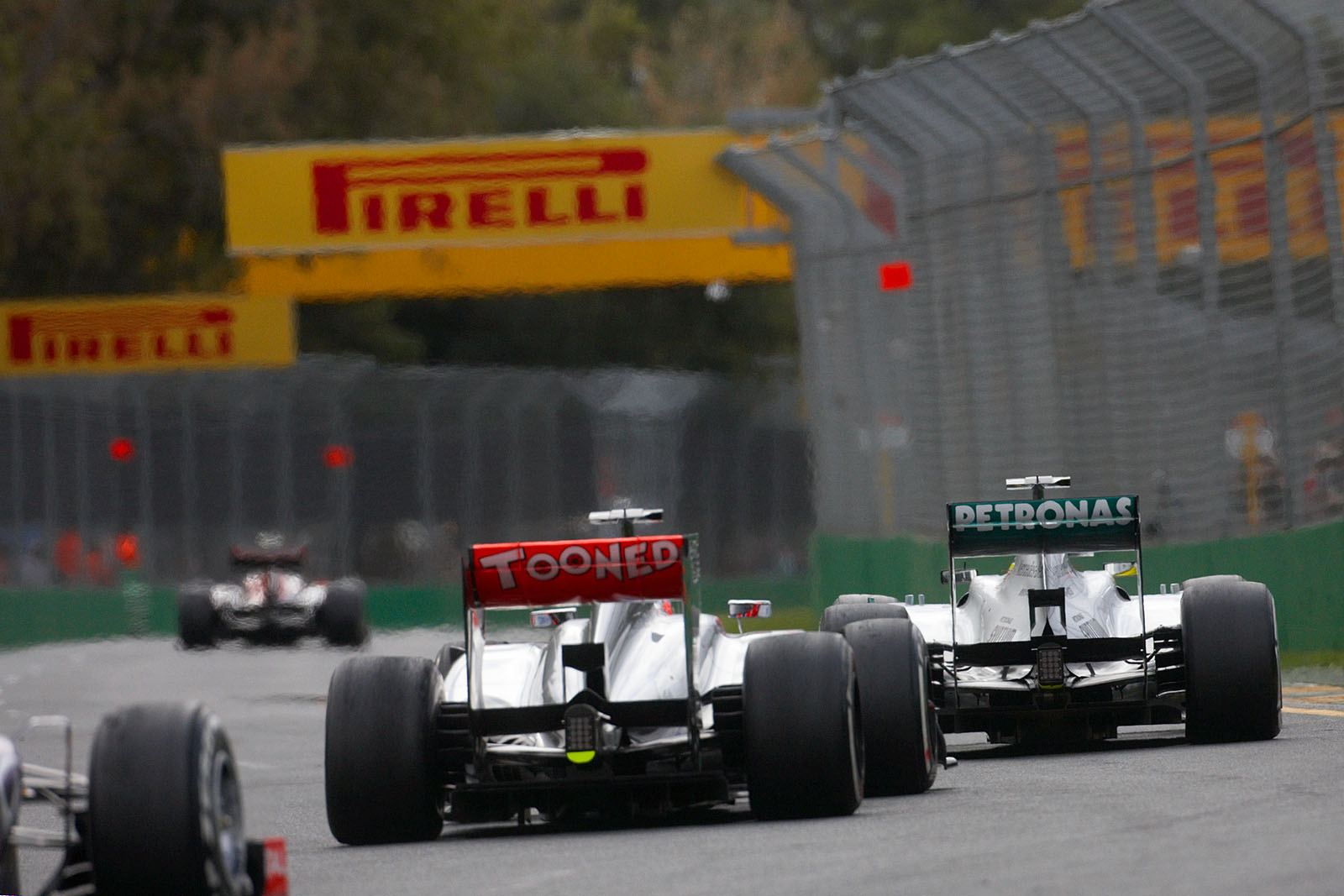 Mercedes GP racer Nico Rosberg closey followed by Jenson Button in a McLaren-Mercedes