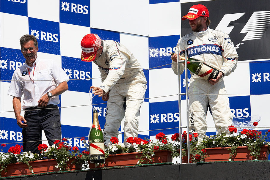 Race winner Robert Kubica shares his champagne bottle with the BMW Sauber team