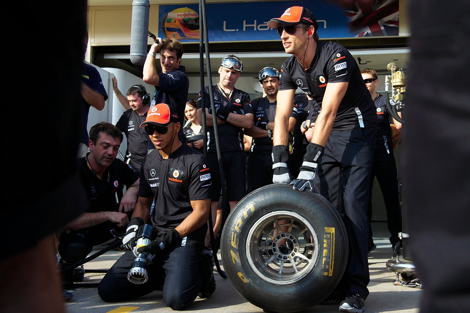 Lewis Hamilton and Jenson Button practise pit stops with the McLaren team for a BBC movie