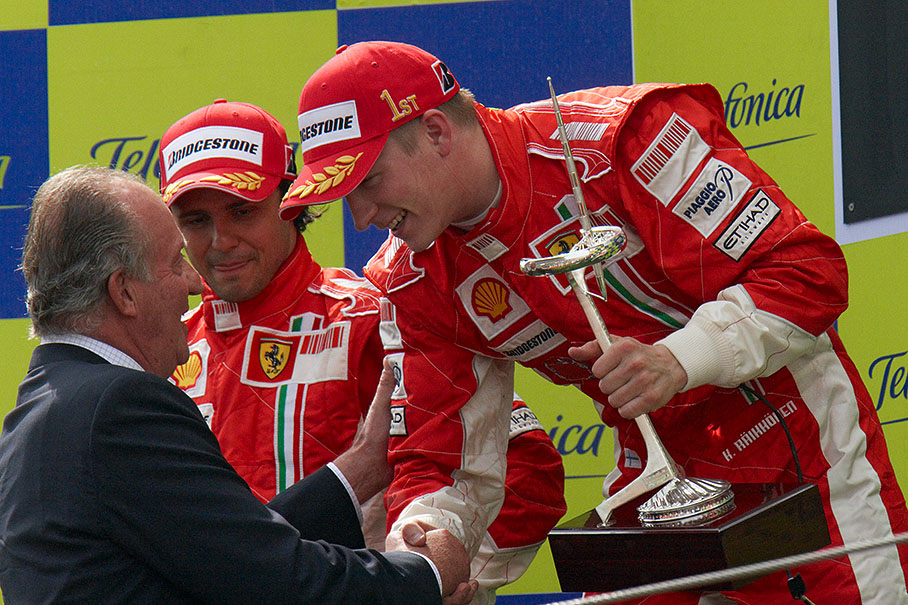 Kimi Raikkonen gets a strong handshake from King of Spain Juan Carlos