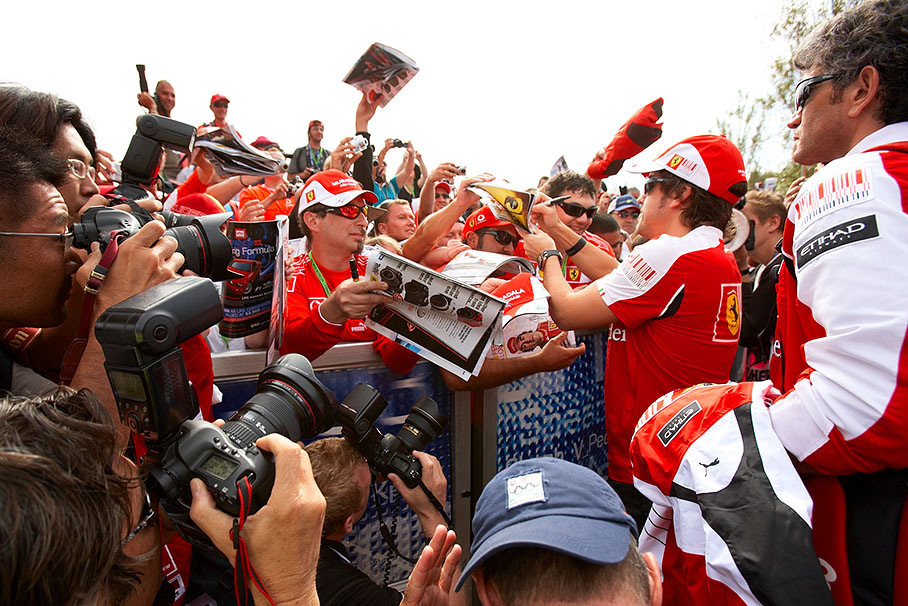 Fernando Alonso gives autographs to Ferrari fans