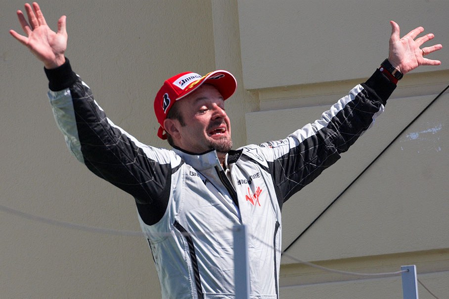 Race winner Rubens Barrichello cheers up on podium