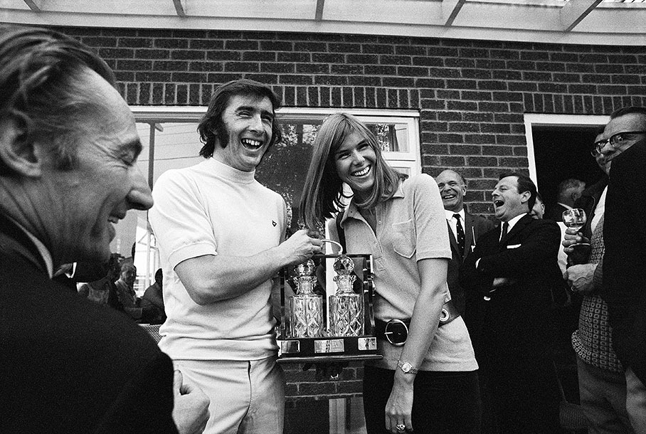 Jackie Stewart and his wife Helen receive a honoury present from the BRDC during the British GP weekend 1969