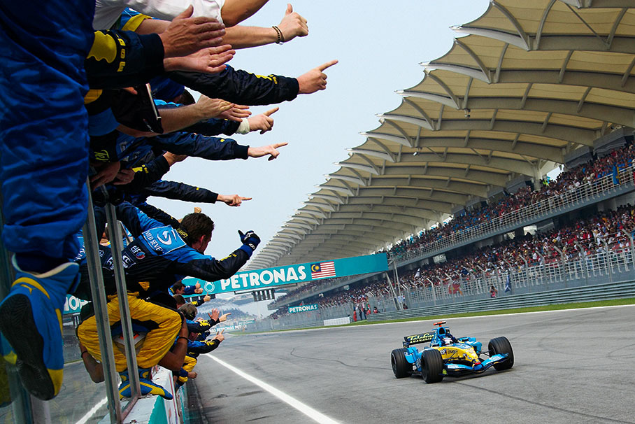 Winner Fernando Alonso passing his cheering team