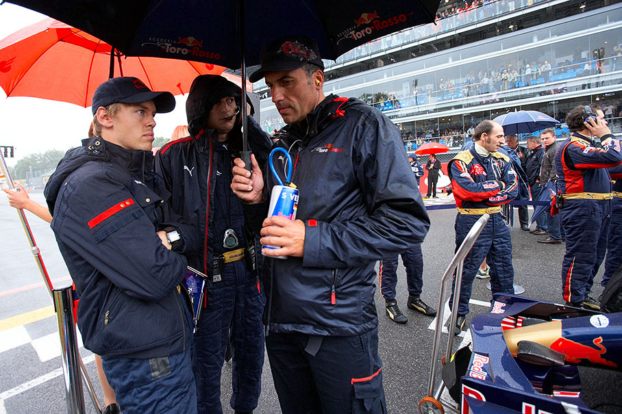 Sebastian Vettel and Toro Rosso engineers on the grid at pole position
