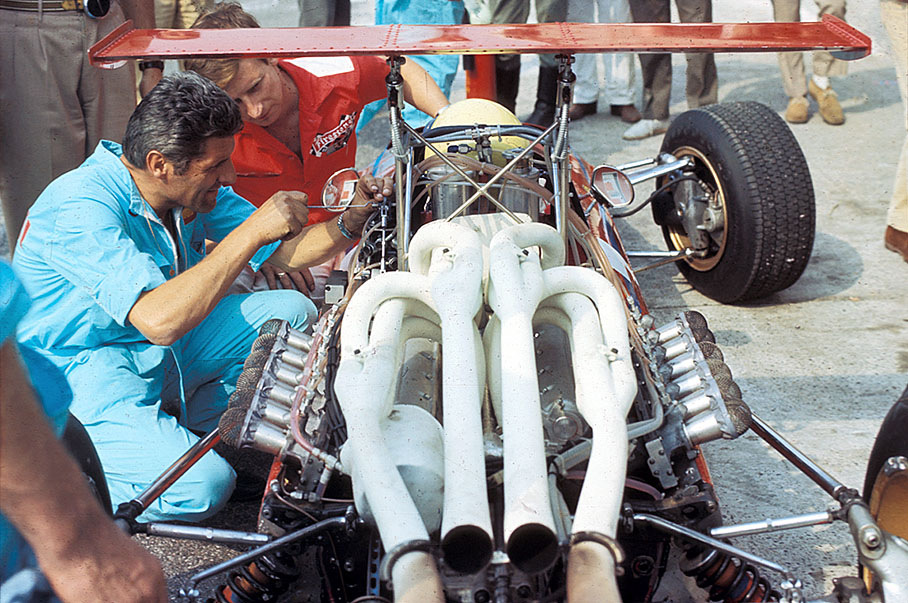 Mechanics work on Derek Bell's Ferrari 312