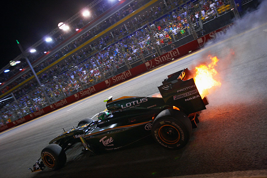Heikki Kovalainen's Lotus-Cosworth pulls over with a burning rear 3 laps before the end of the race