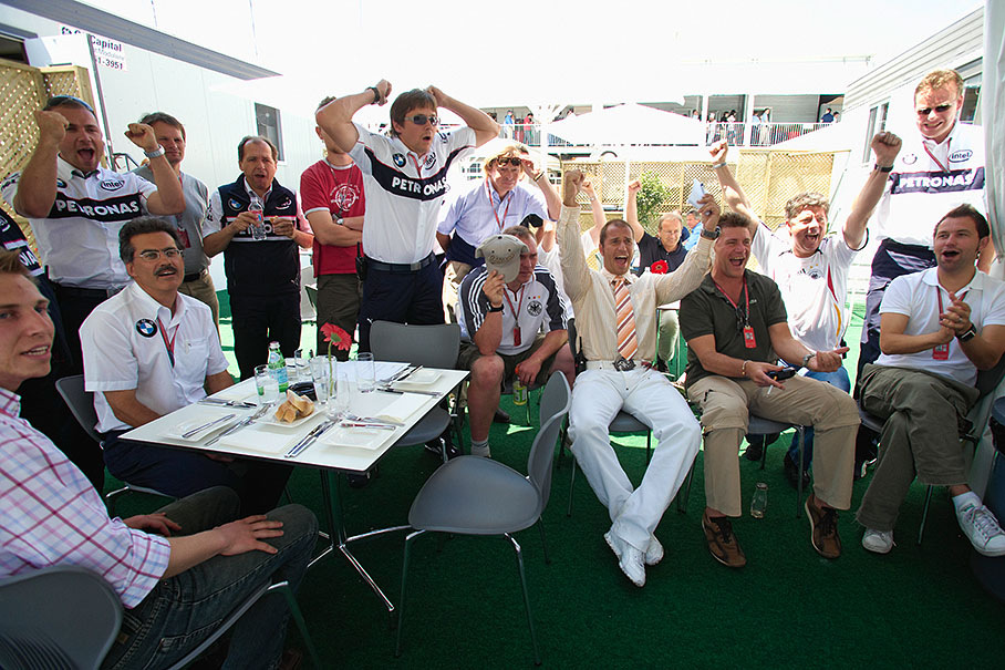 Journalists watching an exciting FIFA football match in BMW Sauber team's hospitality