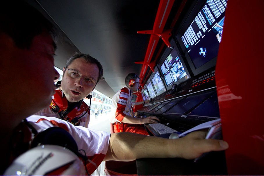 Team principal Stefano Domenicali speaks with Hirohide Hamashima of Bridgestone at Ferrari's pitwall command center