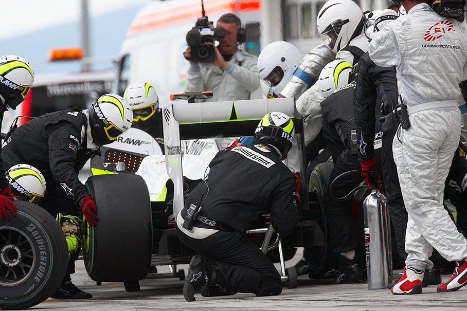 Jenson Button receives a service at Brawn pits
