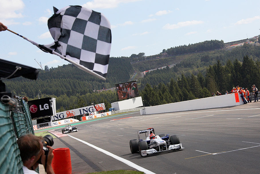 Fourth placed Robert Kubica takes the checquered flag in front of BMW Sauber team mate Nick Heidfeld