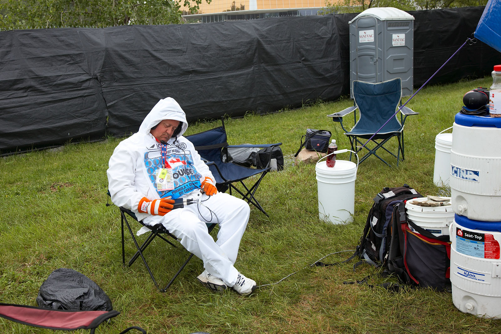 A tired track marshal takes a nap before a rainy session on Friday morning