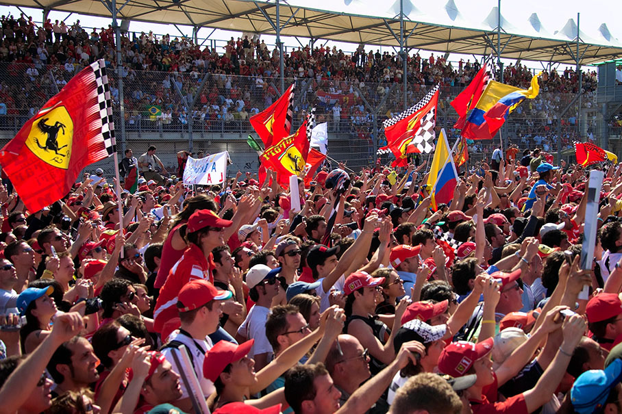 A sea of waving arms and flags on the grid