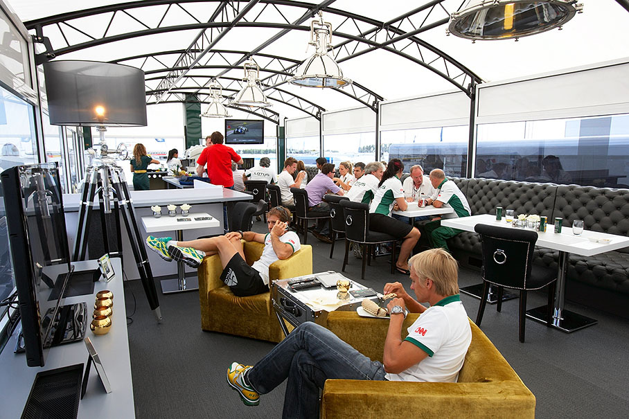 Kovalainen and Trulli relax with TV in the comfortable new Lotus motorhome